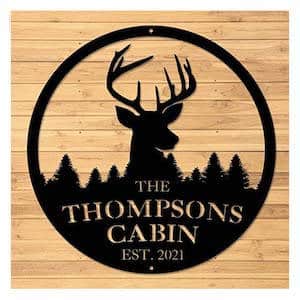 Deer antler wall art that says "The Thompsons Cabin"