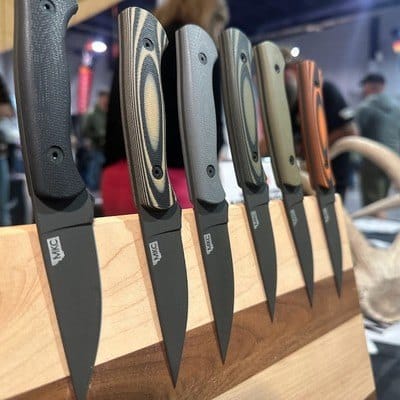 Six Skinning Knives with different colored handles lined up on a display