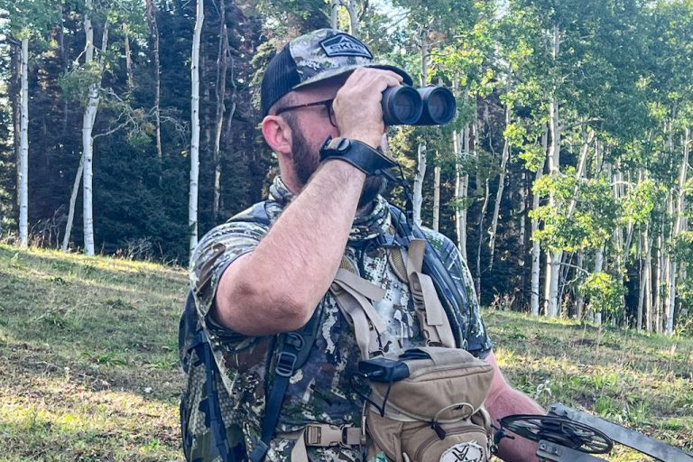 Hunter looking through Maven glass while searching for elk on a Colorado hunt