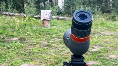 Spotting scope pointing towards an archery target in the distance on a September elk hunt in 2022