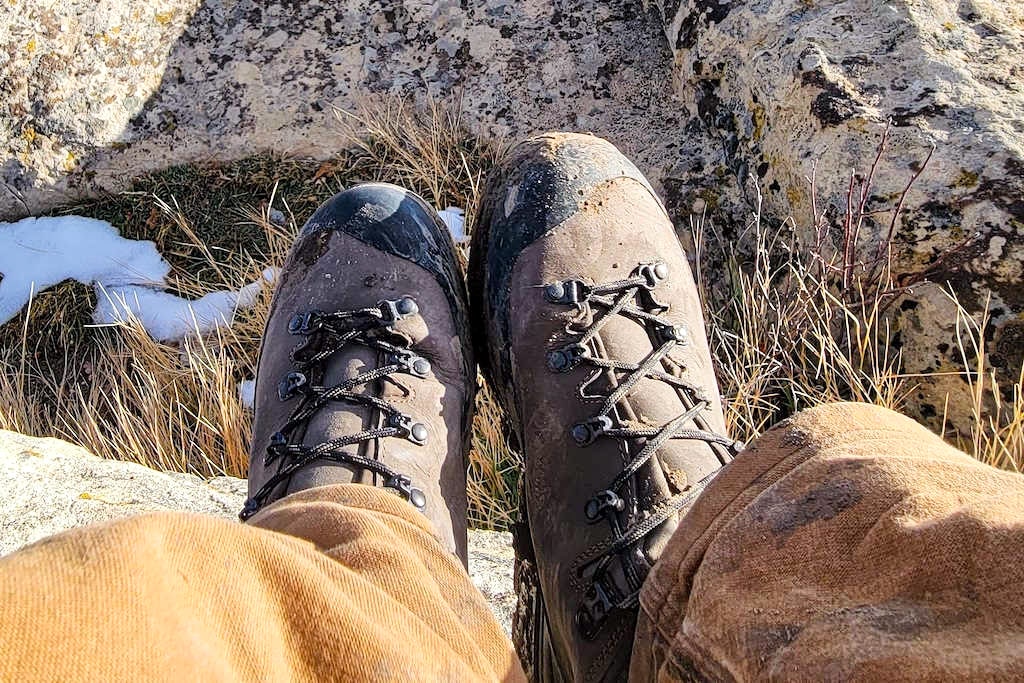Two leather hunting shoes kicked up on a rock