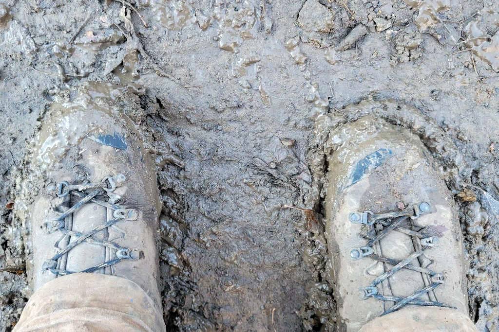 Muddy hunting footwear shot from above