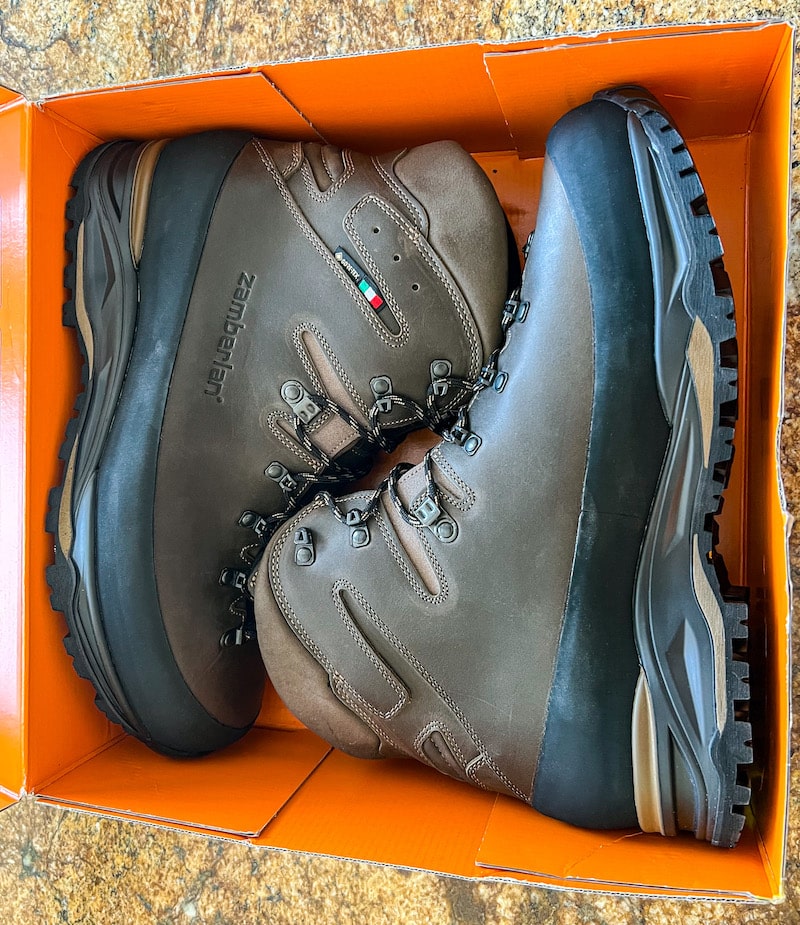 Pair of dark brown backcountry hiking boots in an orange box