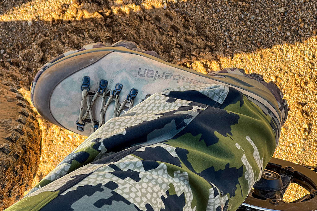 Foot on an eBike pedal with a beefy tire on red Arizona dirt