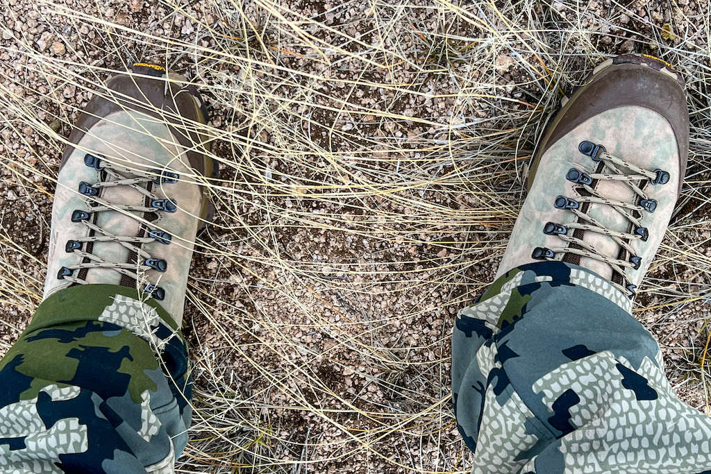 View of two feet in brush and gravel on a hunt in Arizona