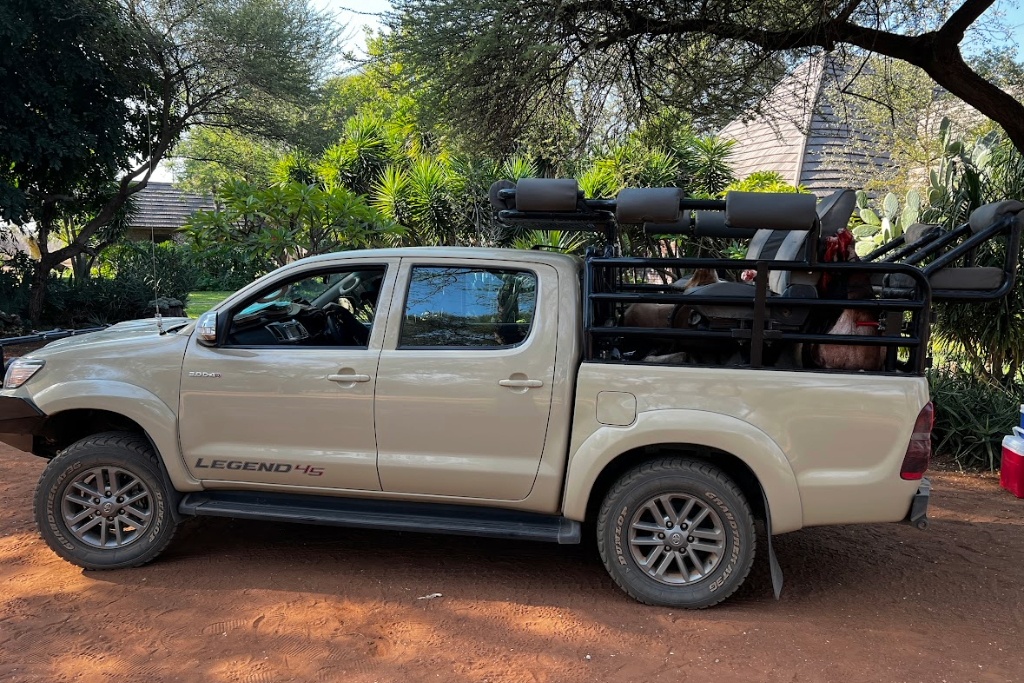 hunting safari truck with seats in the bed of the truck to view wildlife from