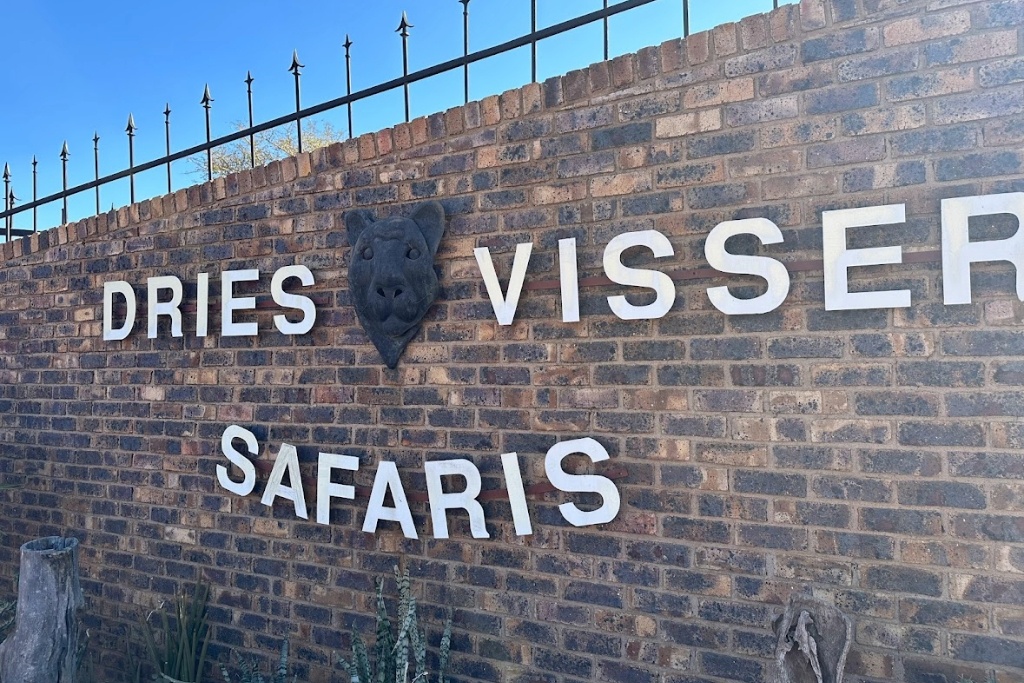 Dried Visser Safaris Sign On Brick Wall