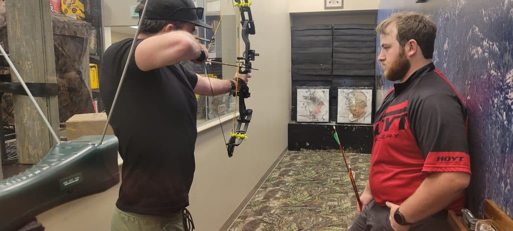 noel checking his draw weight at scheels before heading into the field