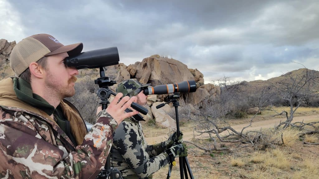 coues deer hunters looking though high powered binoculars and a spotting scope