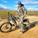 bakcou mule eBike with a hunter checking the map on his phone wearing kuiu camo