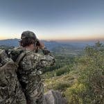 Elk hunter glassing at sunrise across open Colorado backcountry during archery elk season