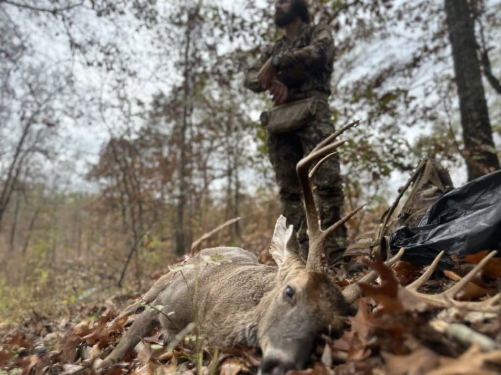 Southern whitetail buck taken with a bow by a hunter wearing Kryptek hunting apparel