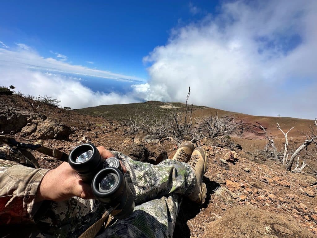 Hunter glassing from a high ridge above the clouds with Vortex binoculars